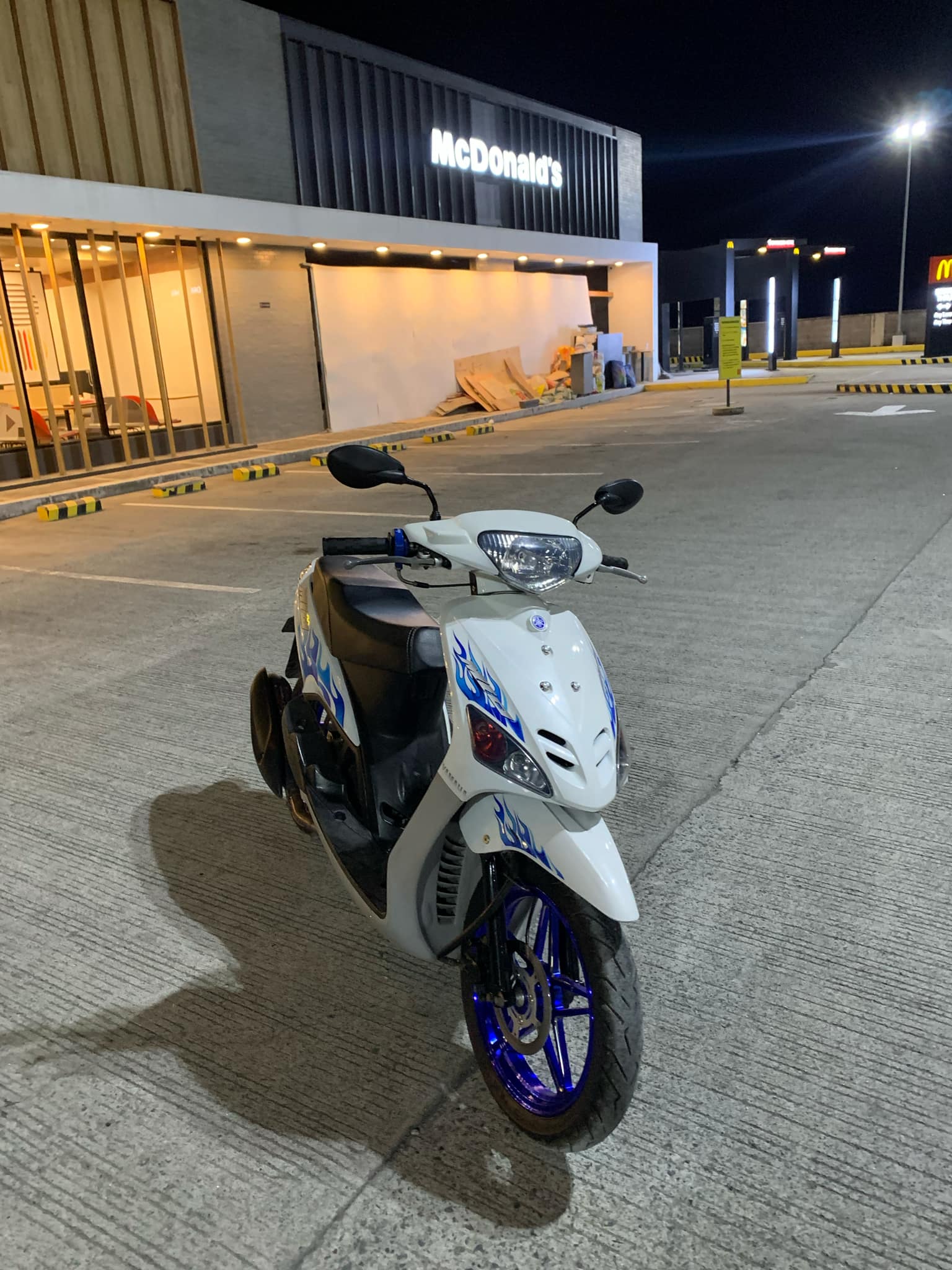 White electric motorcycle model E5 with sleek modern design and digital dashboard